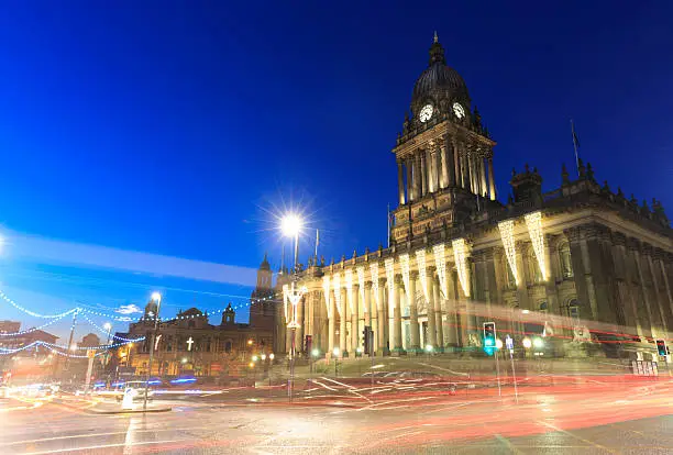 Leeds Town Hall at night with traffic on The Headrow. 