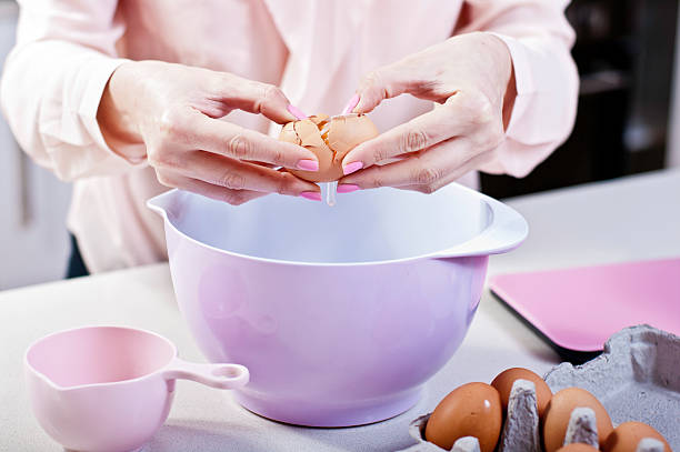 Cracking an Egg into Mixing Bowl in pink themed Kitchen