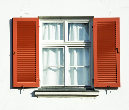 four old blue windows with cracked paint on window shutter