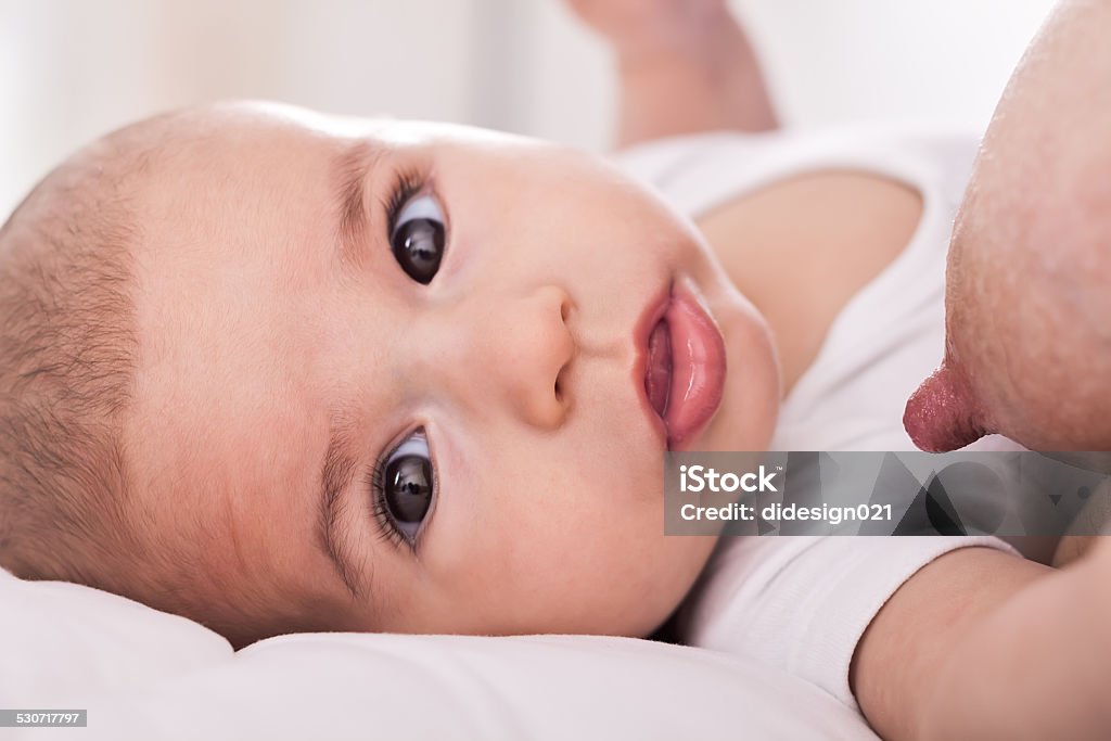 Beautiful innocence hungry baby sucking close up Beautiful innocence hungry baby sucking Adult Stock Photo