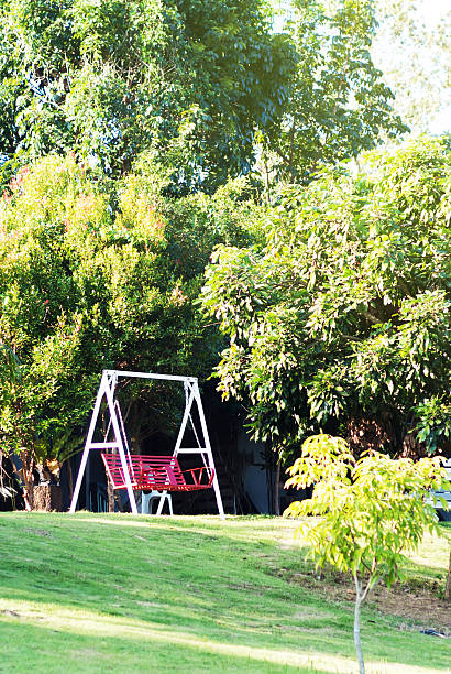 Garden patio swing chair in sun light .
