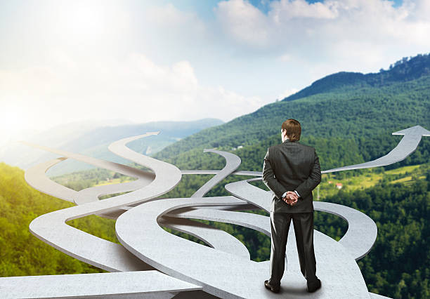 istock Businessman stands choosing his way 530719257