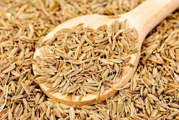 istock Cumin seeds macro and wooden spoon as background 530727981