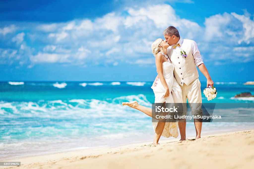 Bride and broom kissing on the beach Bali Wedding Stock Photo