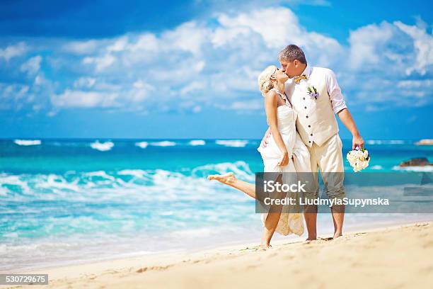 Bride And Broom Kissing On The Beach Stock Photo - Download Image Now - Wedding, Caribbean Sea, Beach