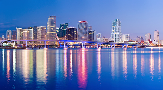Panoramic view of the downtown Miami skyline at twilight, USA. Reflection in the still water.