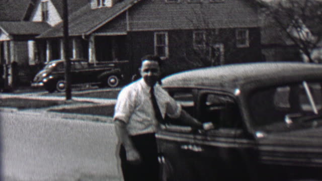 1939: White collared working man smoking pipe car owner suburban pride.