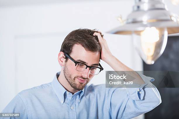 Young Man Scratching Head Stock Photo - Download Image Now - 20-24 Years, 20-29 Years, 2015