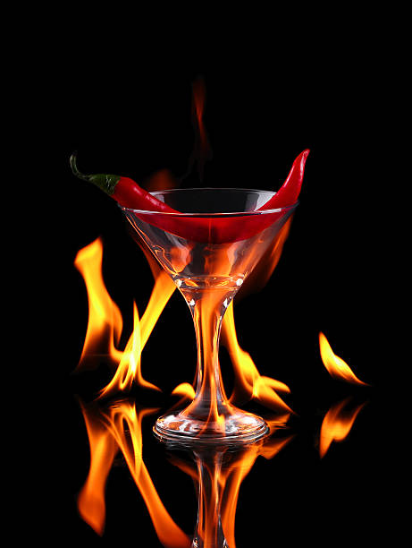 istock Hot chili pepper in a martini glass with a fire 530732795