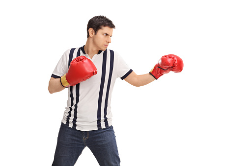 Young angry man with red boxing gloves isolated on white background