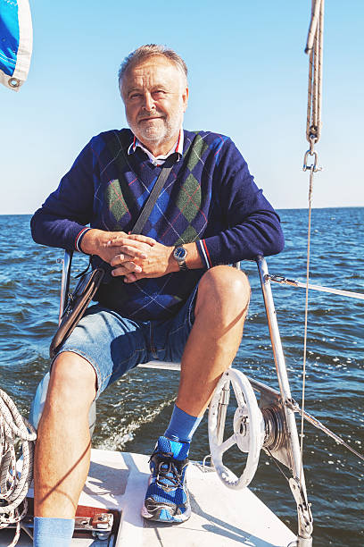 istock elderly man on yacht at sea 530742258