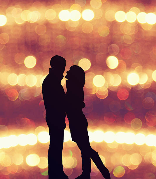 istock Young couple silhouette with a colorful blurred background 530742464