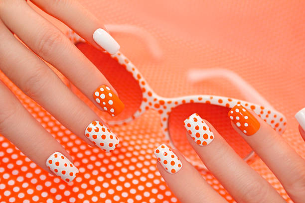 istock Sunny orange manicure with dots . 530743340