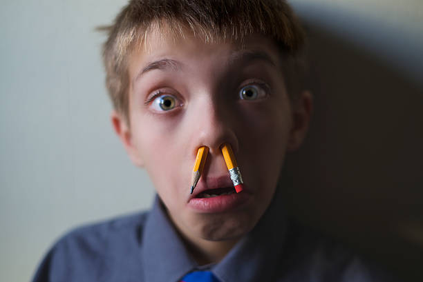 istock Mad student amazed with split pencil in the nostrils 530743509