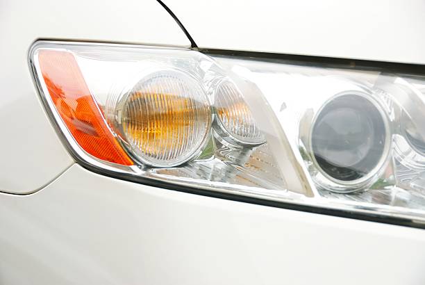 istock Close-up of an Automobile Headlight on a White Vehicle 530743703