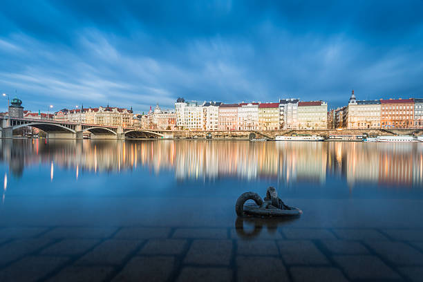 Prague Riverside View between two bridges at night with view of the Dancing House.