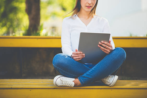 istock young woman with tablet in summer 530743862