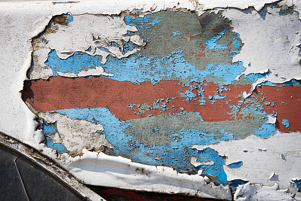 Close up of old, peeling paint on a wooden boat.