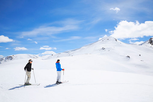 Snow skiing couple enjoys in  beautiful winter snow landscape  Livigno