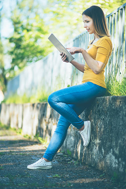 istock young woman with tablet in summer 530744496