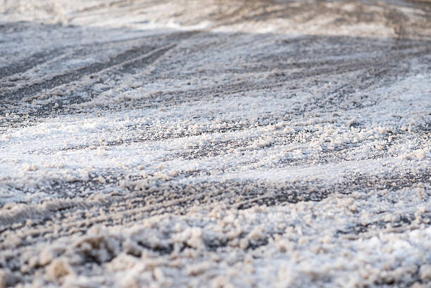 snow covered road with car tracks stock photo