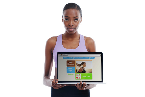 A portrait of a sporty woman showing a webpage on a laptophttp://195.154.178.81/DATA/shoots/ic_783850.jpg