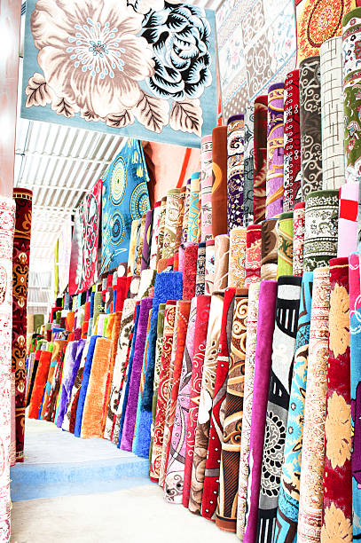 istock Heap of rolled up rugs in rug store 530745242