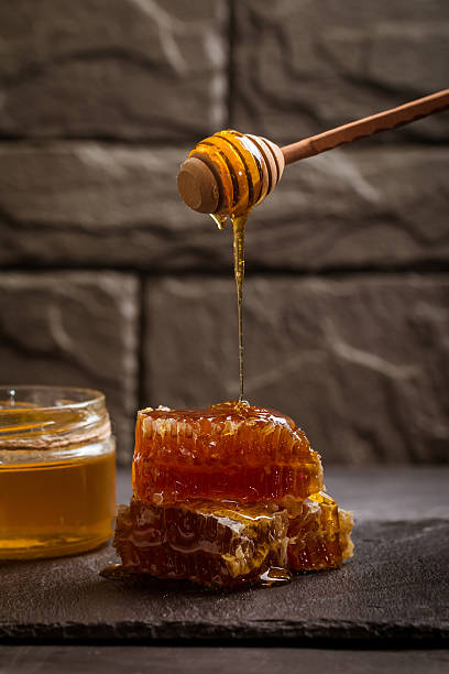 istock Honey dripping from a wooden honey dipper 530745292
