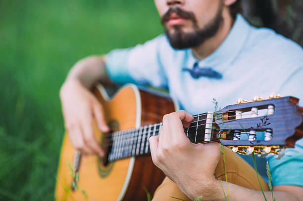 istock the guy playing guitar on the lawn. 530745688