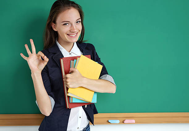Happy smiling student showing okay gesture.