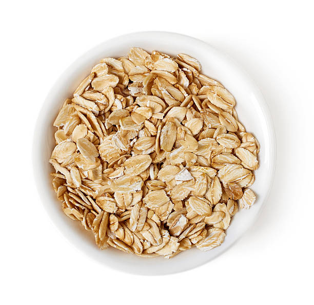 istock Bowl of oat flakes on white background, top view 530747254