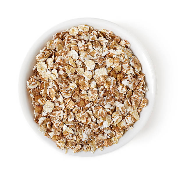 istock Bowl of oat flakes on white background, top view 530747290
