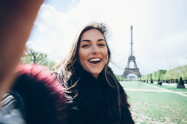 Photo of Happy young woman making selfie