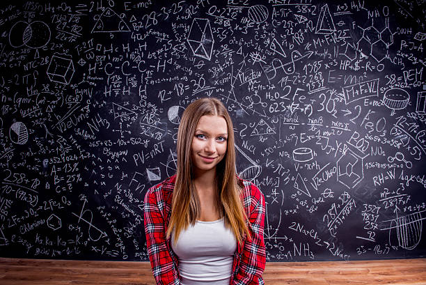 istock Student against a big blackboard with mathematical symbols 530748484