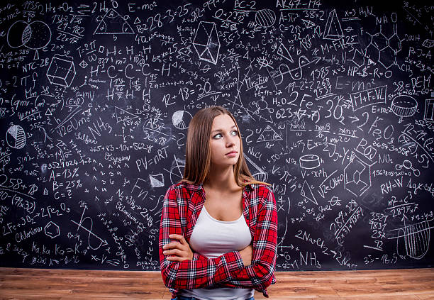 istock Student against a big blackboard with mathematical symbols 530749142