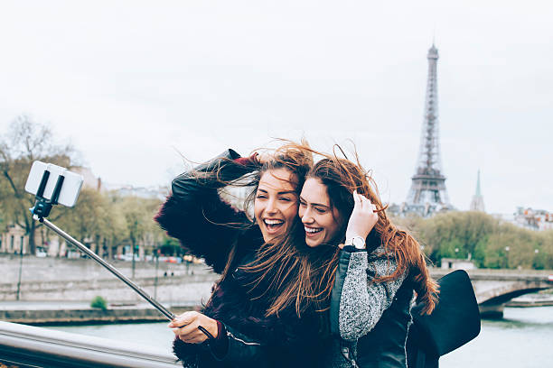 istock Friends making selfie with monopod in front of Eiffel tower 530749920