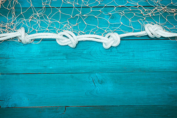 istock Marine Network and rope on white old boards 530750092