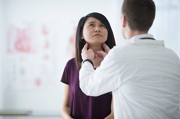 istock Examining a Woman's Throat 530750334