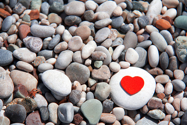 istock pebbles on the beach between the red heart 530750996
