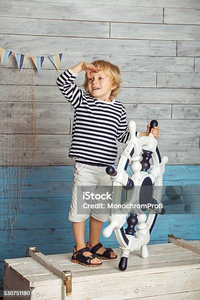 Little Boy Standing With A Steering Wheel Stock Photo - Download Image Now - Blond Hair, Blue, Cheerful