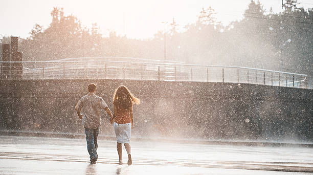 istock couple walking under summer rain 530751434