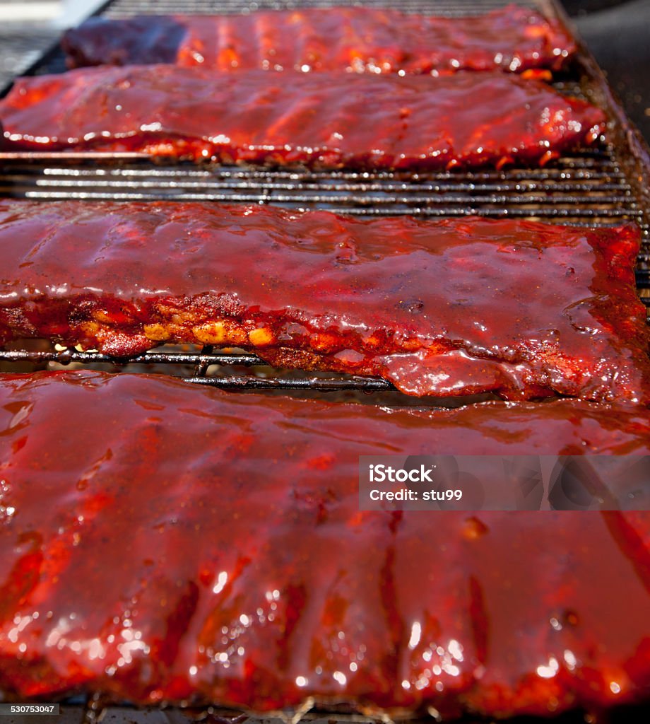 BBQ ribs Racks of BBQ ribs on a hot grill American Culture Stock Photo