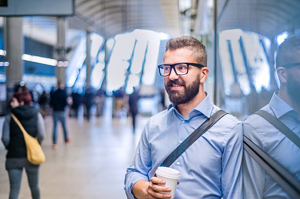 istock Hipster businessman holding a coffee cup, subway station 530753088
