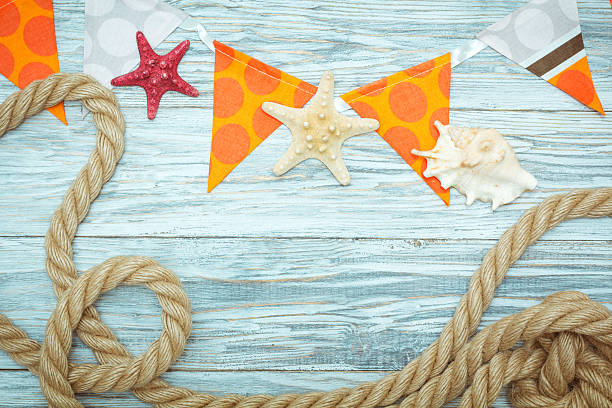 istock sea shells and rope on old boards 530753586