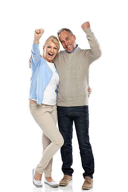 Happy mature couple cheering on white Full length portrait of happy mature couple cheering on white background couple isolated wife husband stock pictures, royalty-free photos & images