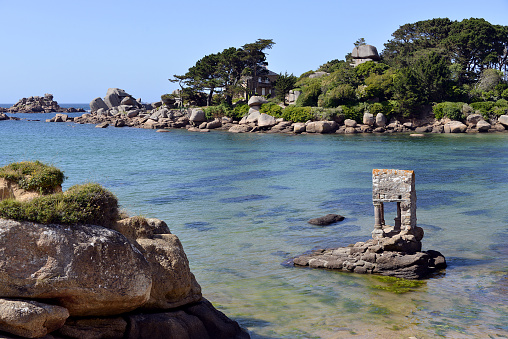 The famous old Oratoire Saint-Guirec building at middle tide on the Pink Granite Coast (côte de granite rose in french) of Ploumanac'h, village in the commune of Perros-Guirec. It is found in the region Bretagne in the Côtes-d'Armor department in the west of France.