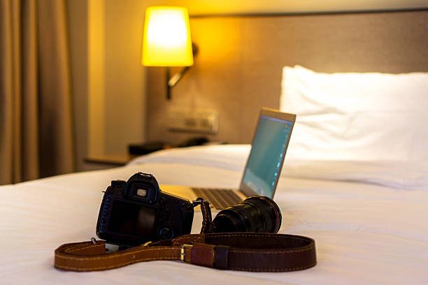 istock camera and laptop on hotel bed 530754634