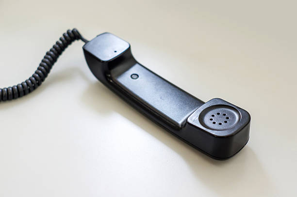 istock black telephone picking on a desk, soft focus. 530755286