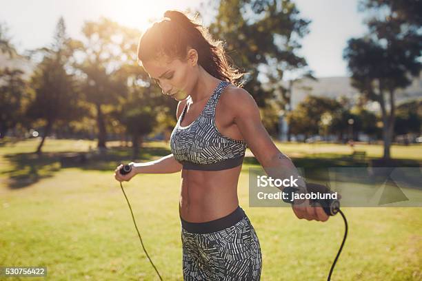 Fit Young Woman With Jump Rope In A Park Stock Photo - Download Image Now - Jumping Rope, Jump Rope, Women