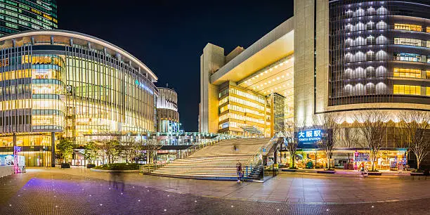 Warm lights illuminating the plaza outside Grand Front Osaka Station, the popular shopping district and transport hub, at night. ProPhoto RGB profile for maximum color fidelity and gamut.